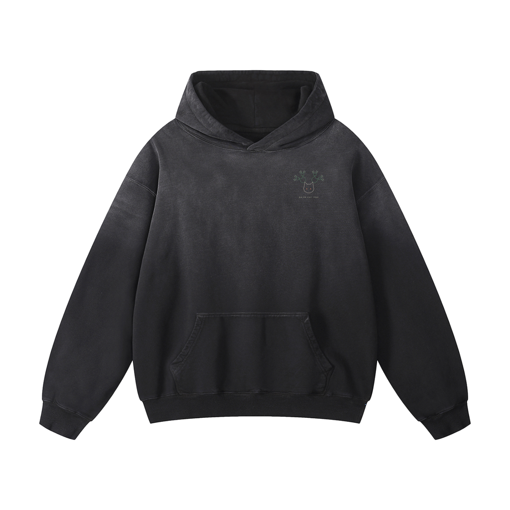 A washed black pullover hoodie with a small printed graphic on the left chest, displayed against a solid white background.