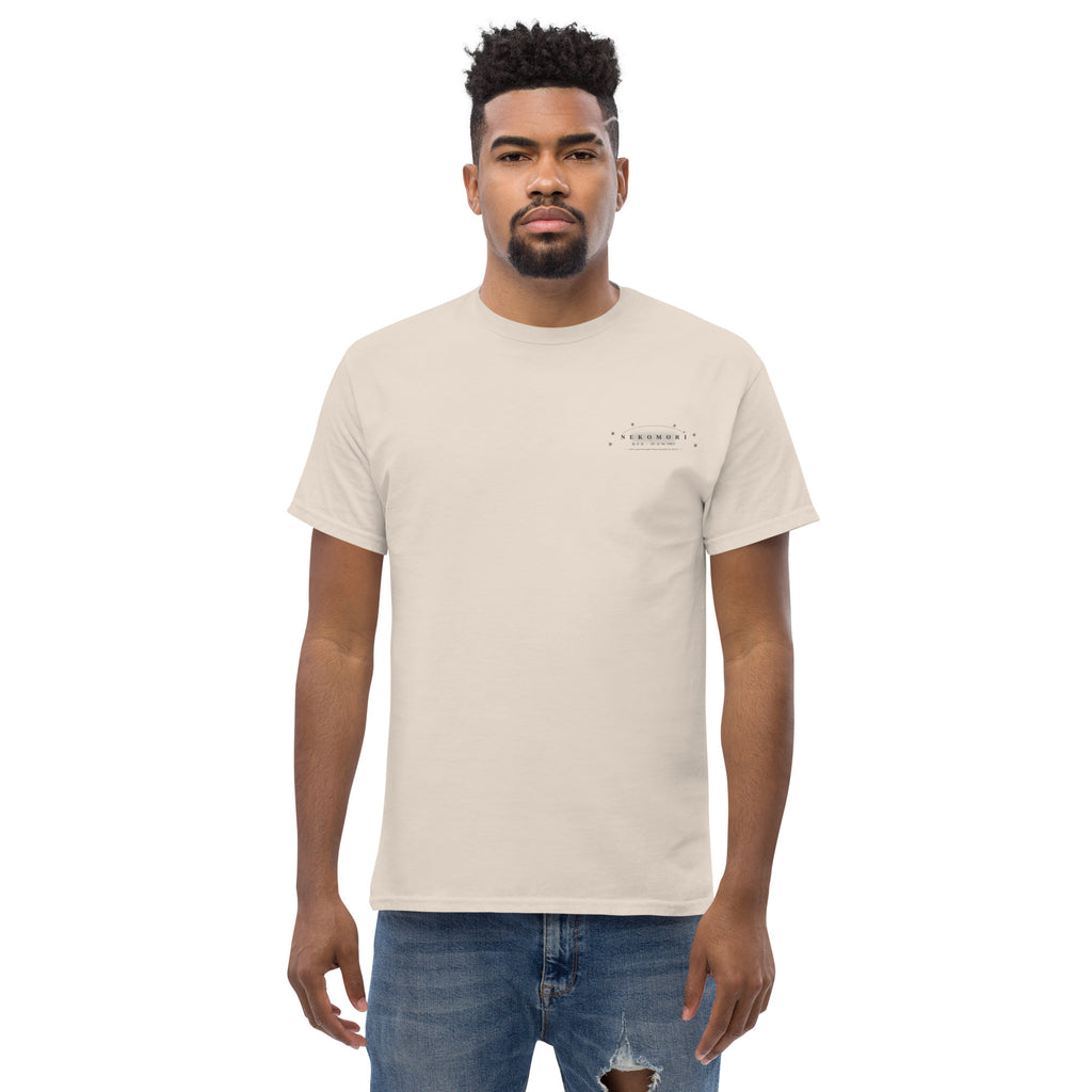 Natural cat t-shirt laid flat from the front, undyed cotton with the small forest-green cat-and-sprout emblem at the chest.