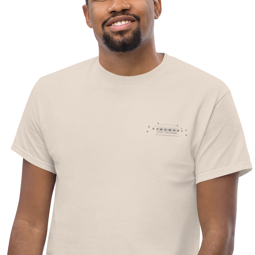 Detail of the Nekomori cat-and-sprout emblem printed small at the left chest of the natural cotton tee.